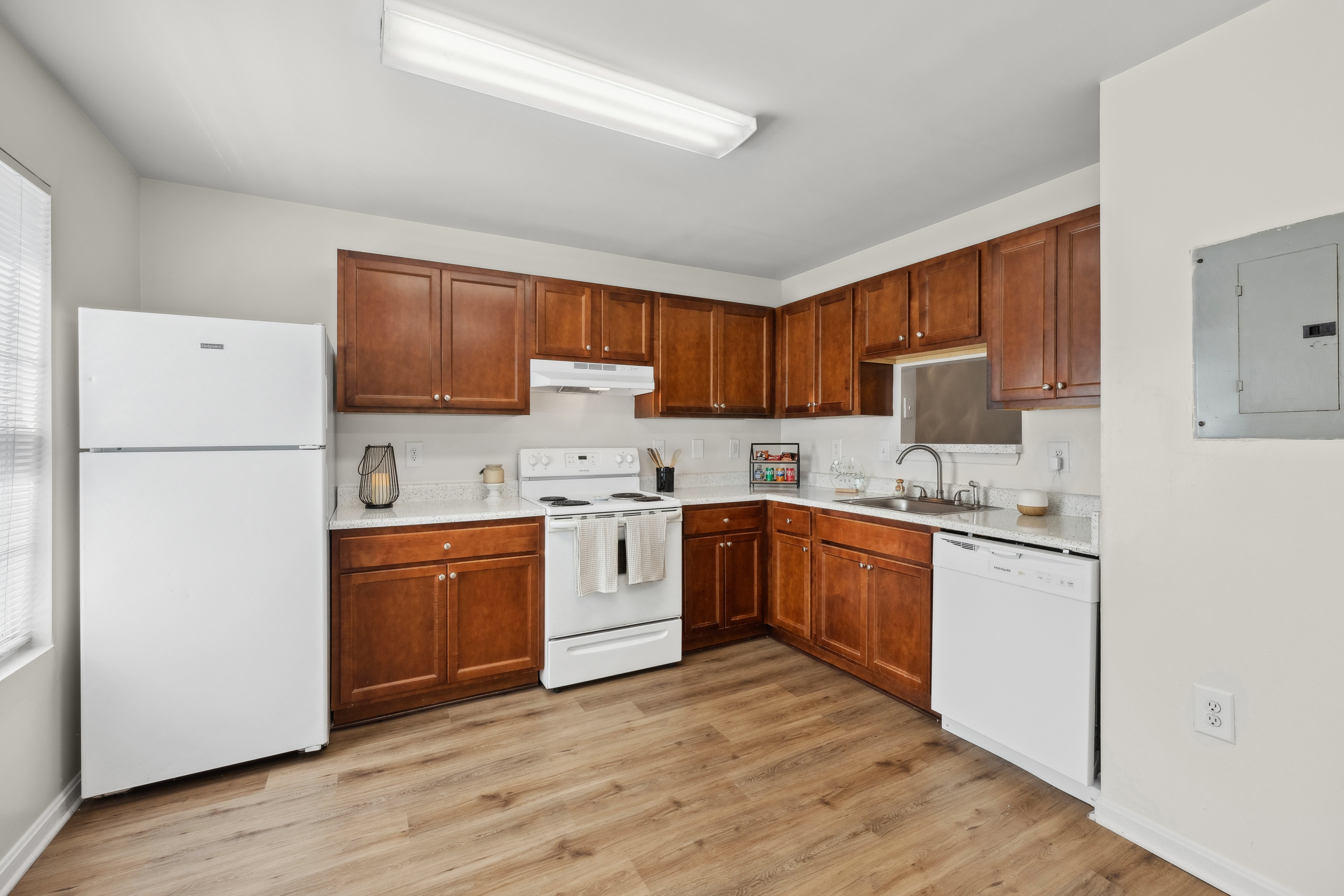 A kitchen with wooden cabinets and white appliances.